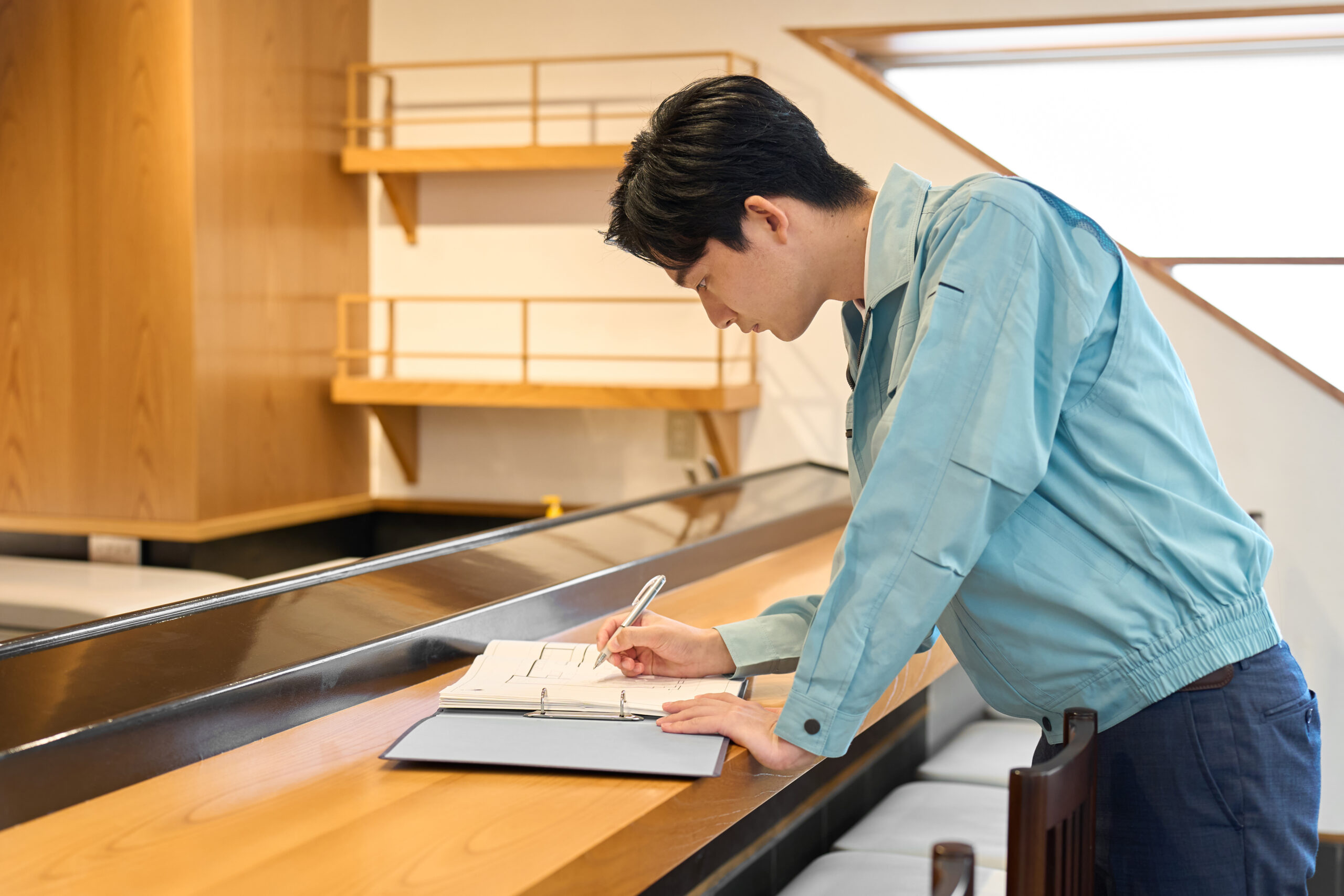 A man checking blueprints at a restaurant